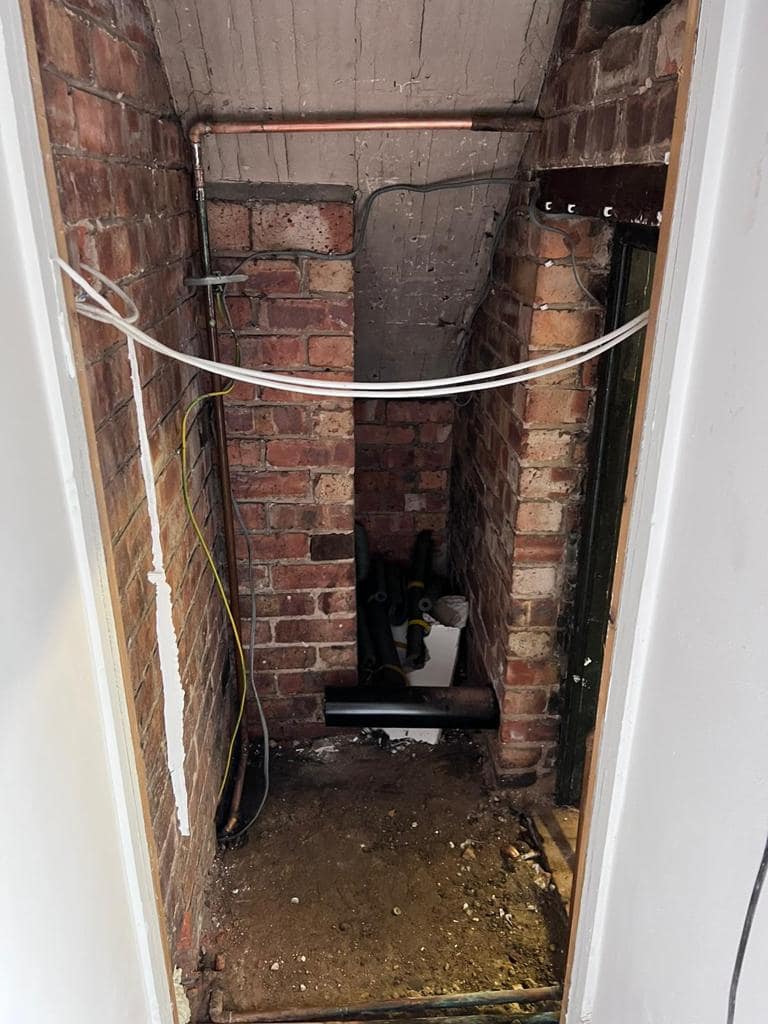 Cloakroom 2: View 1. Existing space stripped back to brick.