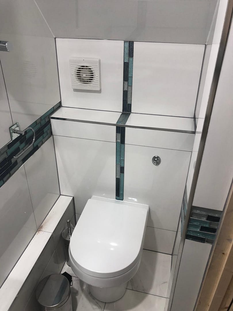 Back to wall toilet with extractor fan in unit