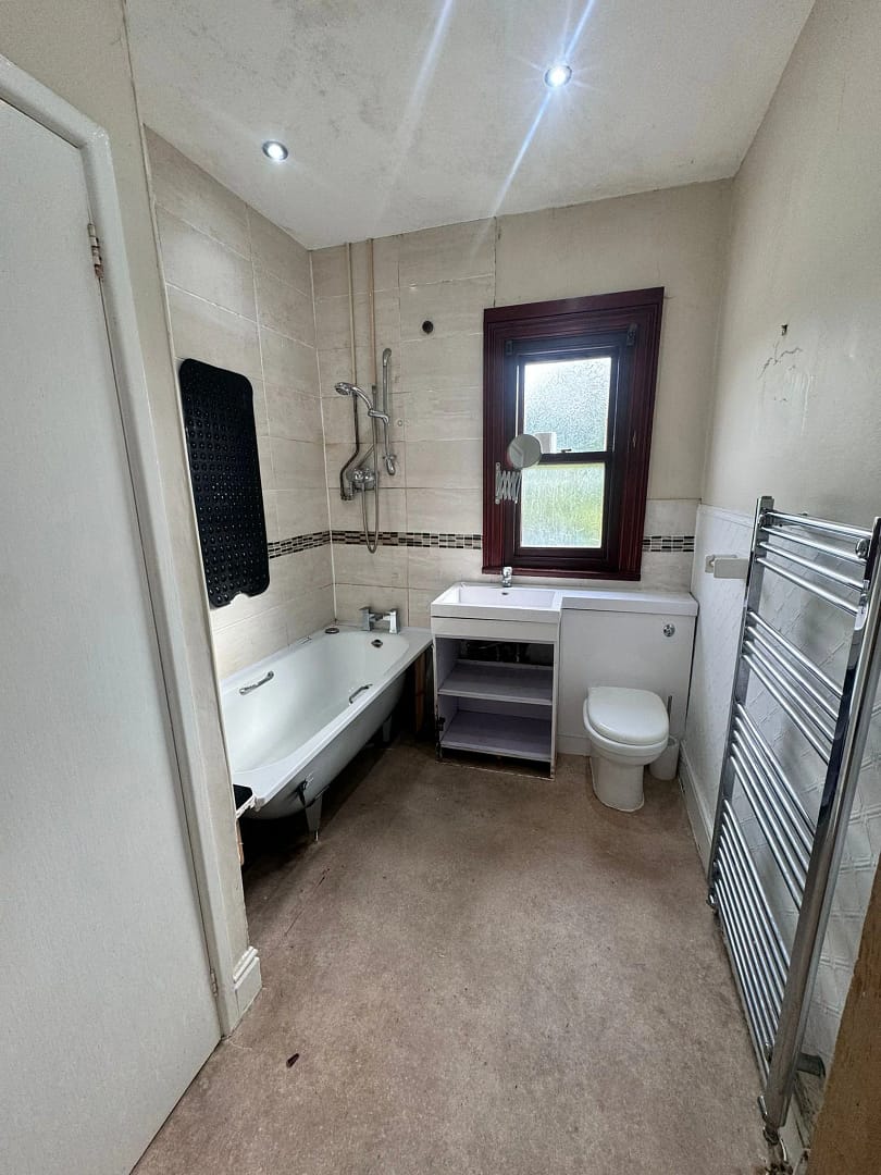 Bathroom 3; Before image 1 showing old bath, sink and towel rail